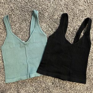 Two boutique cropped tank tops. One green and other black.
